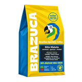 A 250 g bag of Brazuca Brazilian Specialty Coffee, featuring a bright yellow and blue design with a parrot logo, set against a plain white background.
